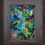 framed mosaic in blues, greens, red by Lynn Bridge