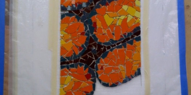orange ammonite fossil mosaic work-in-progress by Lynn Bridge, mosaic artist in Austin, Texas