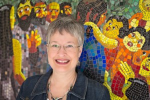 Nina Miller's photographic portrait of Lynn Bridge in front of her mosaic wall in Austin, Texas